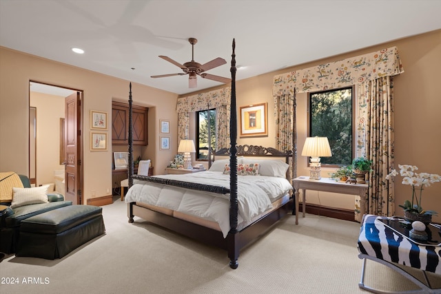 carpeted bedroom with ceiling fan and connected bathroom