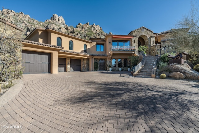 mediterranean / spanish home with a garage and a mountain view