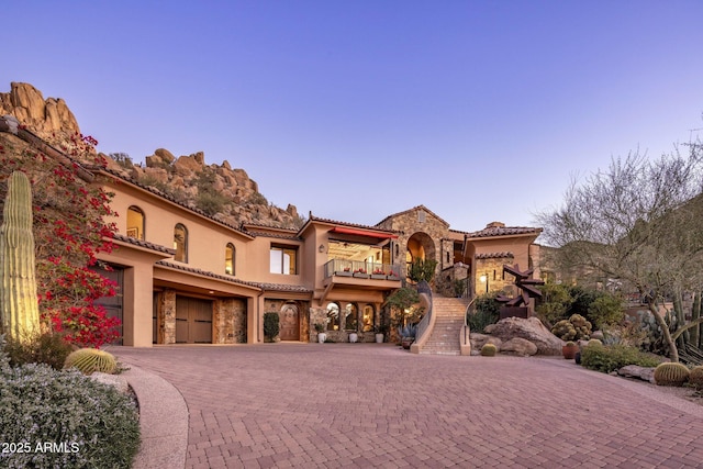 mediterranean / spanish house with a balcony and a garage