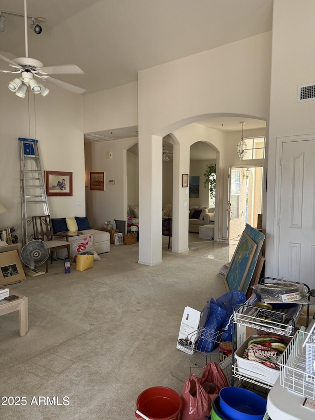 12955 E Sahuaro Dr, Scottsdale, AZ 85259 - living room featuring ceiling fan, arched walkways, carpet flooring, and a high ceiling