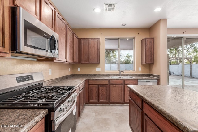 kitchen featuring sink, a wealth of natural light, and appliances with stainless steel finishes