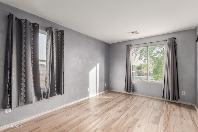 unfurnished room featuring light hardwood / wood-style floors