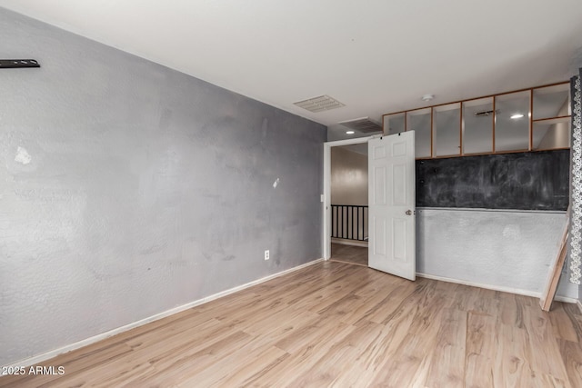 unfurnished bedroom with light wood-type flooring