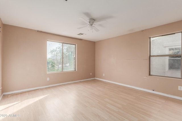 spare room featuring ceiling fan and light hardwood / wood-style flooring