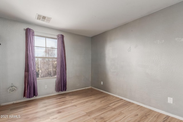 empty room with light hardwood / wood-style floors