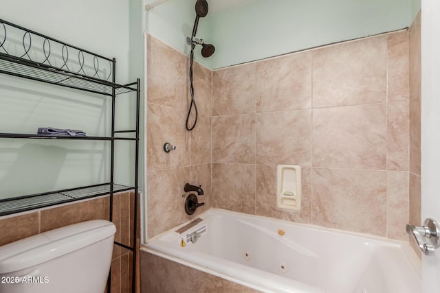 bathroom with tiled shower / bath combo and toilet