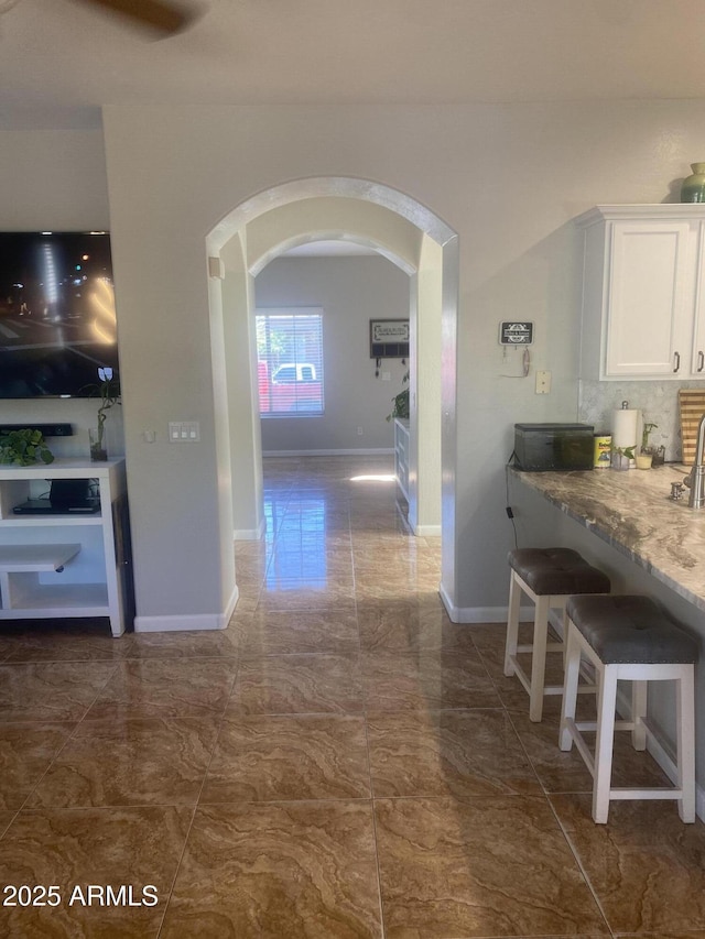 546 E San Carlos Way, Chandler, AZ 85249 - corridor with arched walkways, dark marble finish floors, and baseboards