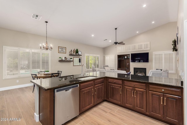 kitchen with pendant lighting, sink, dark brown cabinets, stainless steel dishwasher, and dark stone counters