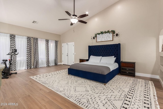 bedroom featuring ceiling fan, wood-type flooring, and high vaulted ceiling