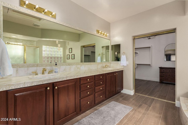 bathroom featuring vanity and decorative backsplash