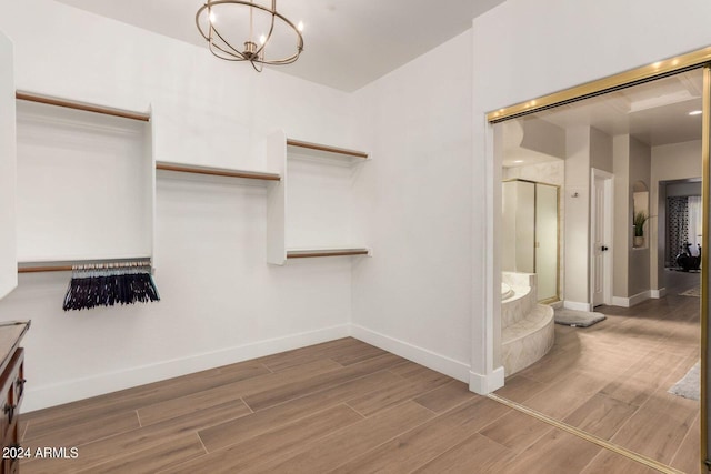 walk in closet featuring an inviting chandelier