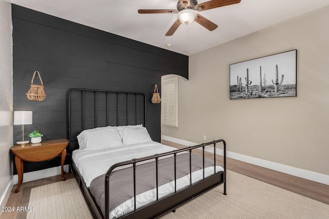 bedroom with wood-type flooring and ceiling fan