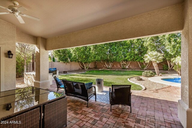 view of patio featuring a fenced in pool and ceiling fan