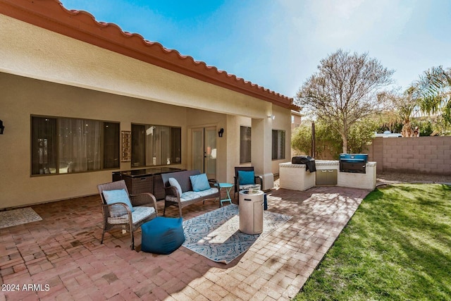 view of patio with grilling area, outdoor lounge area, and an outdoor kitchen