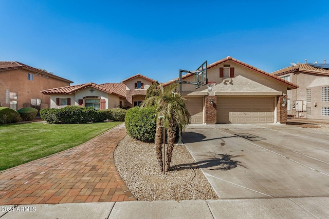 mediterranean / spanish-style house with a garage and a front yard