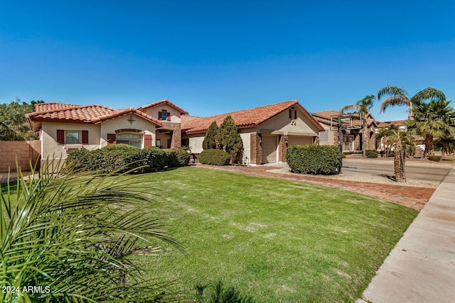 mediterranean / spanish house with a garage and a front lawn