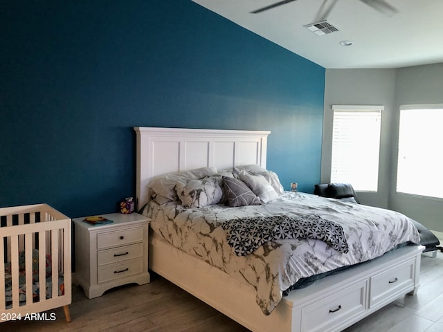 bedroom with ceiling fan and light wood-type flooring