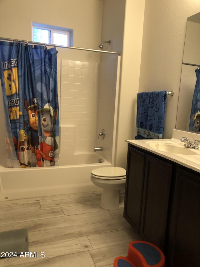 full bathroom featuring vanity, shower / bathtub combination with curtain, wood-type flooring, and toilet