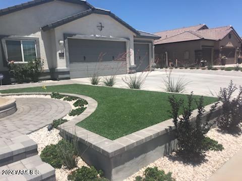 view of front of home featuring a garage and a front yard