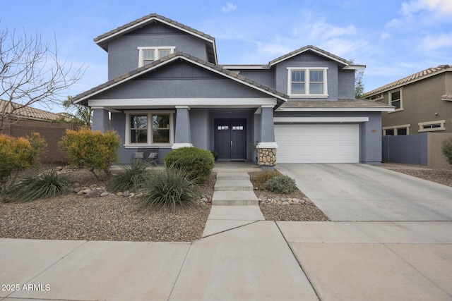 view of front of property with a garage, driveway, a tiled roof, fence, and stucco siding