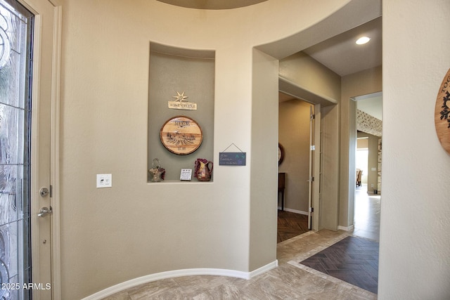 hallway featuring parquet flooring