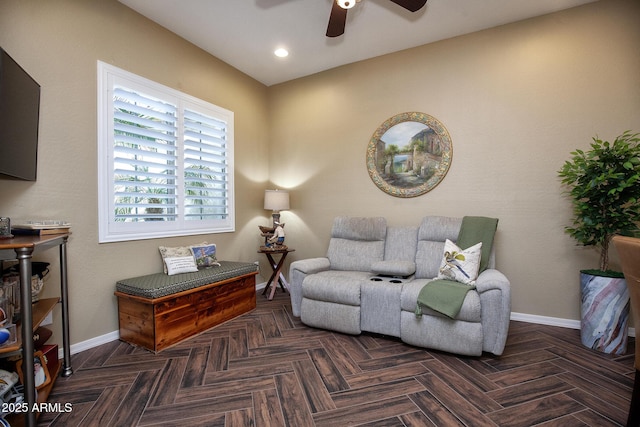 living area with dark parquet flooring and ceiling fan