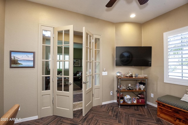 interior space with french doors, ceiling fan, and dark parquet flooring