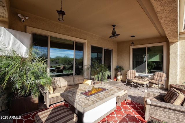 view of patio featuring an outdoor living space with a fire pit