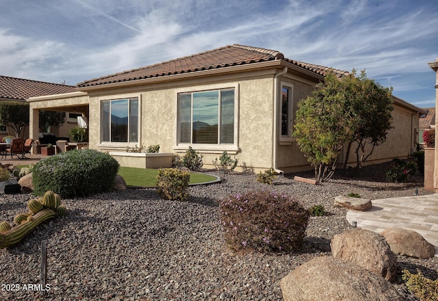 rear view of property featuring a patio