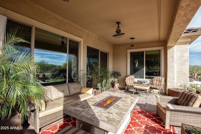 view of patio featuring an outdoor living space with a fire pit