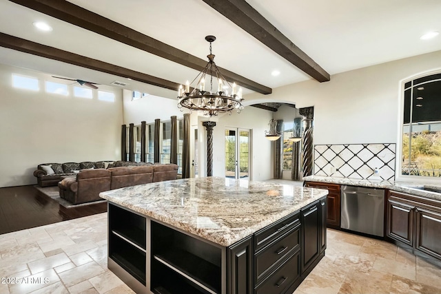 kitchen featuring decorative light fixtures, tasteful backsplash, dishwasher, beamed ceiling, and a center island