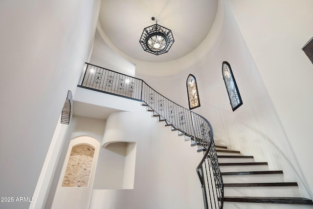 stairway featuring a high ceiling