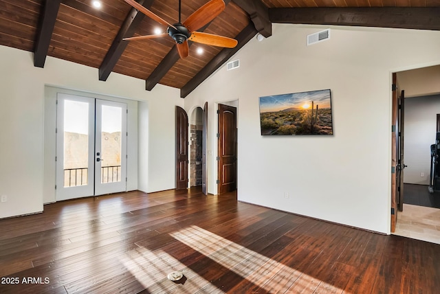 empty room featuring beamed ceiling, dark hardwood / wood-style flooring, ceiling fan, wood ceiling, and french doors