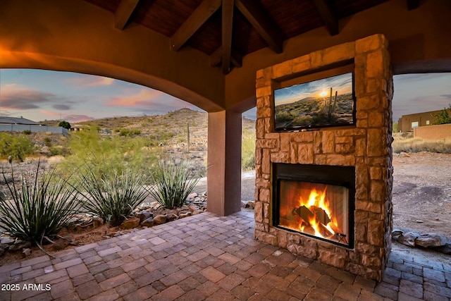 view of patio featuring an outdoor stone fireplace