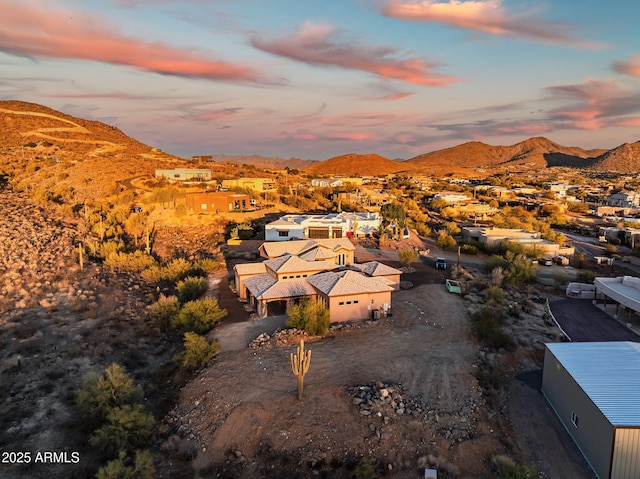 aerial view at dusk featuring a mountain view