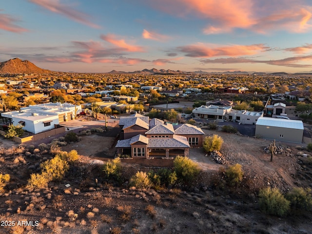 aerial view at dusk featuring a mountain view