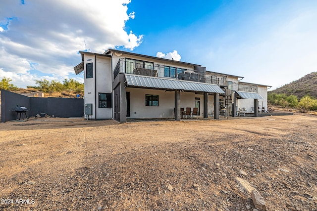 rear view of property featuring a wooden deck