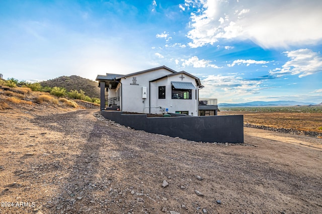 rear view of property featuring a mountain view