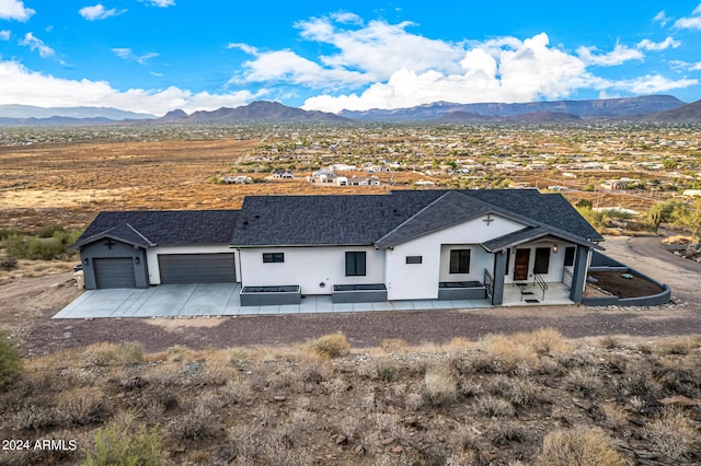 view of front facade with a garage and a mountain view