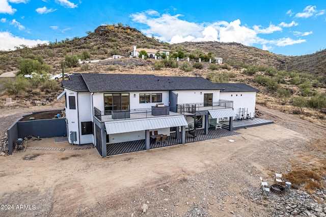 view of front of home with a deck with mountain view