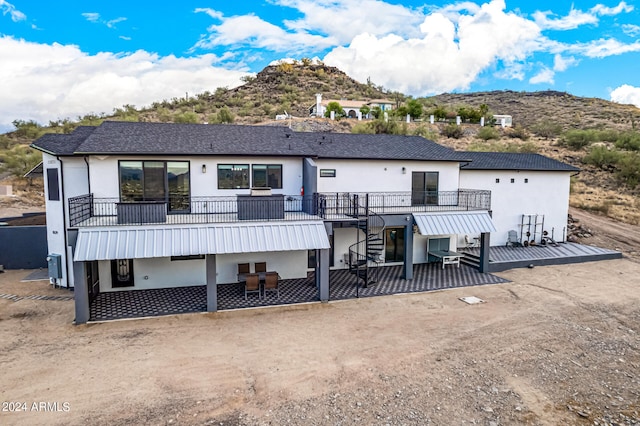 back of house featuring a deck with mountain view