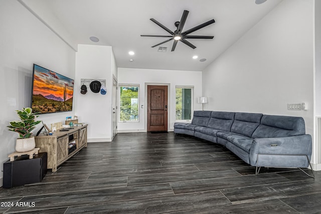 living room with ceiling fan, lofted ceiling, and dark hardwood / wood-style floors