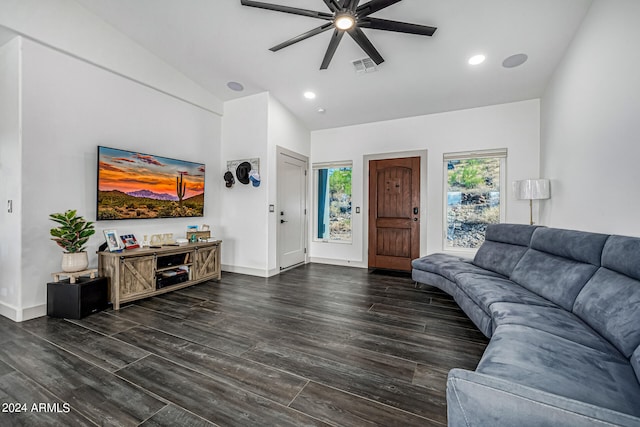 living room with lofted ceiling, ceiling fan, and dark hardwood / wood-style flooring