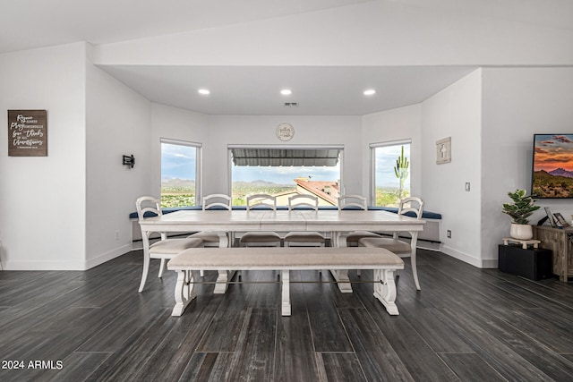 dining space with lofted ceiling and dark hardwood / wood-style floors