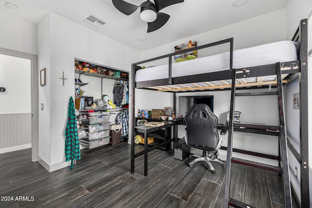 bedroom with ceiling fan and dark wood-type flooring