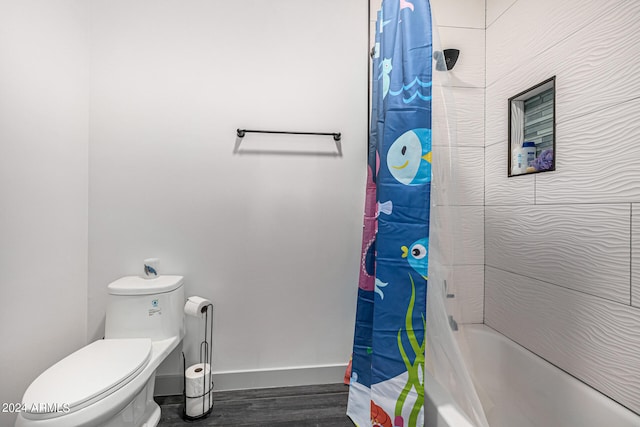 bathroom with wood-type flooring, shower / bath combo, and toilet