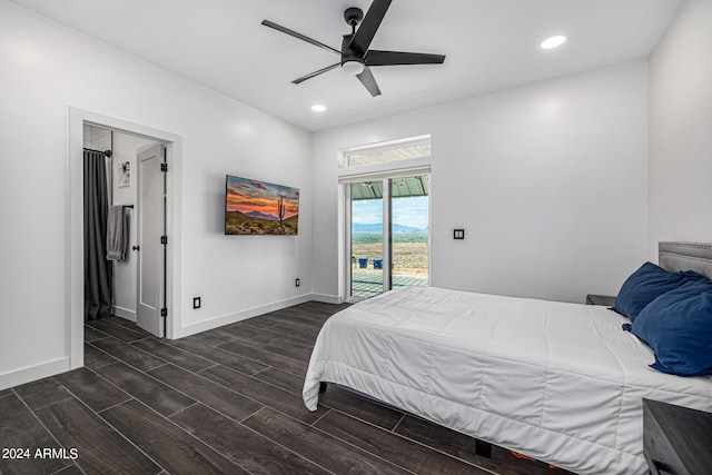 bedroom featuring dark hardwood / wood-style flooring, ceiling fan, and access to exterior