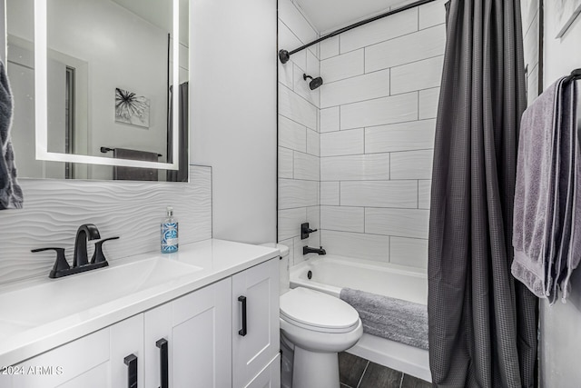 full bathroom featuring vanity, wood-type flooring, shower / tub combo, toilet, and decorative backsplash