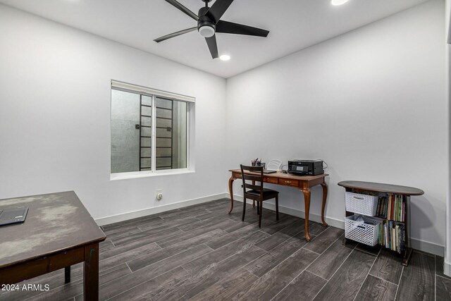 home office with dark hardwood / wood-style floors and ceiling fan