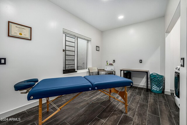 recreation room with dark hardwood / wood-style floors